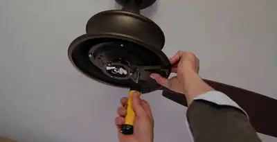 Electrician installing ceiling fan mounting bracket and fixture in Salt Lake City, UT
