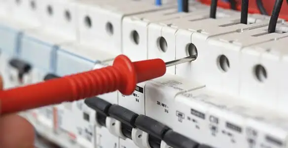 Electrical contractor testing circuit breakers during electrical repair in West Jordan, UT