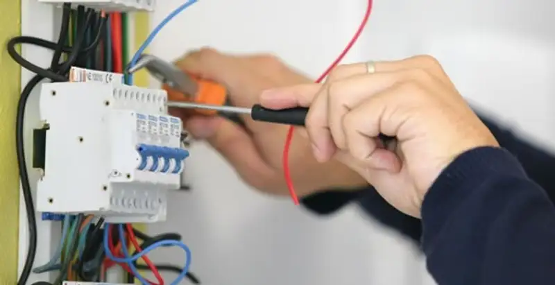 Electrician installing and adjusting circuit breakers in an electrical panel in Salt Lake City, UT