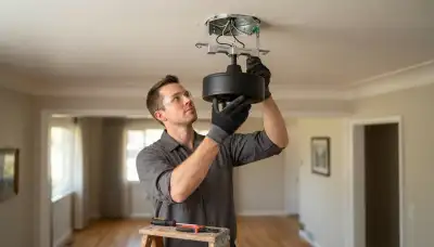 Electrician installing a fan-rated box and ceiling fan motor in a Salt Lake City, UT home
