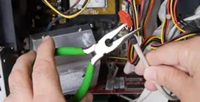 Licensed electrical contractor performing electrical repair with tools in West Jordan, UT