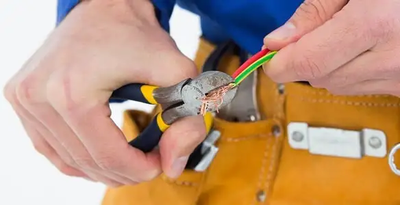 licensed electrician securing electrical wiring with professional tools during service work in Salt Lake City, UT